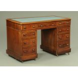 A Victorian mahogany pedestal desk, with blue tooled leather writing surface,