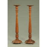 A pair of Victorian mahogany bedpost torcheres, with circular tops,