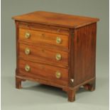 A small mahogany three drawer chest with brushing slide,