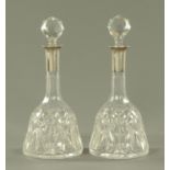 A pair of George V silver mounted and cut glass mallet shape decanters,