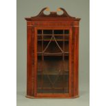 A George III inlaid mahogany hanging corner cupboard,