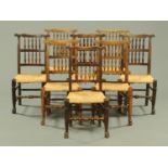 A set of eight rush seat spindle backed dining chairs.