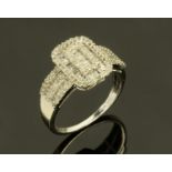 An American 9 ct white gold diamond cluster ring, with baguette cut diamonds, ring size P/Q.