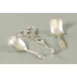 A pair of silver sugar nips, makers initials IG, two silver caddy spoons, Peter and William Bateman,