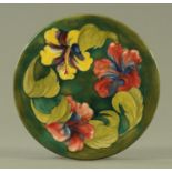 A Walter Moorcroft "Hibiscus" pattern charger, mid 20th century, with green ground,