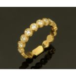 An 18 ct yellow gold diamond set ring, rubover, 10 diamonds, size N.