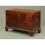 A George III mahogany blanket box, having a carved border and base, with side carrying handles,