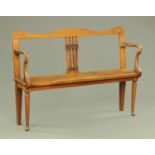 A 19th century mahogany hall seat, with shaped top rail, square spindle back rest,