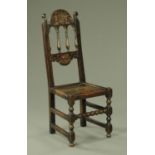 An early 18th century dark oak side chair,