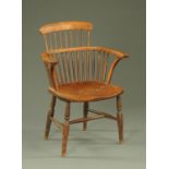 A 19th century Windsor type armchair, with bowed shaped top rail, spindled back,