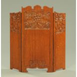 An Arts & Crafts carved oak three fold fire screen, dated 1909. Width fold 35 cm, height 76 cm.