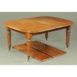 A Victorian mahogany extending dining table with two leaves,