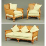 An early 20th century walnut and bergere three piece suite,