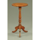 A George III mahogany wine table, with circular top, turned column and downswept legs.