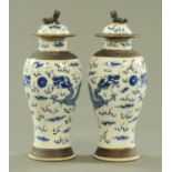 A pair of Chinese crackleware blue and white vases and covers, late 19th century,