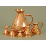 A collection of six copper measures, three gallons to half gill,