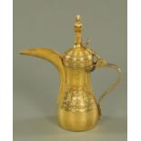 A gilt dallah, 20th century, of typical form, with engraved coat of arms for Qatar,