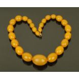 A string of butterscotch amber olive shaped beads. Largest bead 3 cm diameter, 56.2 grams.