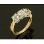 An 18 ct yellow gold three stone diamond ring, round cut and claw set, size M (see illustration).
