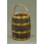 A 19th century coopered oak bucket, with hollow brass bale handle. Height 40 cm.