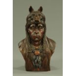 A hand carved and painted wood bust of a native American,