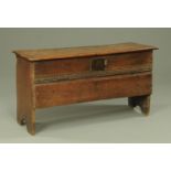 An early 18th century oak coffer, the two plank top above a chip carved front,