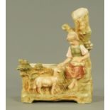 A Royal Dux figural planter, early 20th century, modelled as a young girl with lamb sat by a well,