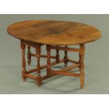 An 18th century oak drop leaf dining table,