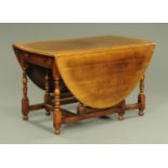 A Titchmarsh & Goodwin for Barkers of Northallerton George III style oak gate legged dining table,