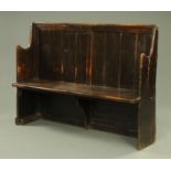 A 19th century dark stained pine settle,