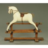A carved and painted rocking horse, late 19th/early 20th century, with felt and leather saddle,