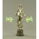 An Art Deco style metal figural table lamp, with green iridescent glass shades.