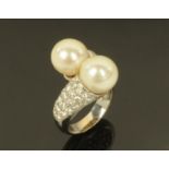A pearl and diamond crossover ring,