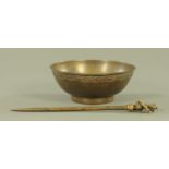 A Nepalese bronze bowl, diameter 22 cm and a large calligraphy pen.