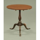 A George III oak tripod table, with mahogany crossbanded edge and snap action. Diameter 68 cm.
