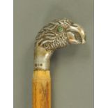 A parasol handle, silver mounted, in the form of a parrot head, London 1922.