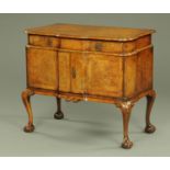 A 1930's walnut veneered and crossbanded serpentine fronted side cabinet in the Queen Anne style,