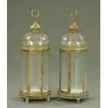 A pair of gilt metal and glass domed lanterns, supported upon short feet, with ring handles.