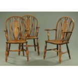 Three Windsor wheelback armchairs, with solid seats, turned legs and stretchers,