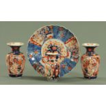 A pair of Japanese Imari vases, circa 1900, with flared rims above reeded bodies,