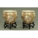 A pair of large decorative Canton style fishbowls on ebonised stands,