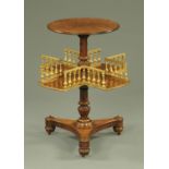 A William IV walnut revolving book table, with circular top and spindle gallery to the lower tier.