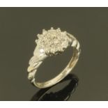 A 9 ct white gold and diamond cluster ring, 0.25 carat, ring size K, 2.6 grams gross weight.