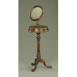 A Victorian gentleman's shaving stand, having an adjustable mirror with moulded edge,