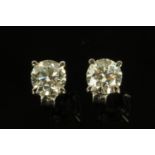 A pair of 18 ct white gold diamond earrings, each +/- 1 carat.