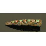 A Chinese silver gilt and enamelled nail guard, inset with semiprecious stones, cased. Length 9 cm.