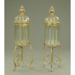 A pair of gilt metal and glass lanterns, on scrolling stands.
