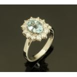 An 18 ct gold aquamarine and diamond cluster ring, aquamarine 1.28 carats, diamonds +/- .