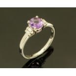 An 18 ct gold purple sapphire and diamond set ring, size M/N.