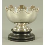 A silver pedestal bowl, Sheffield 1911, with wavy rim with applied scroll decoration,